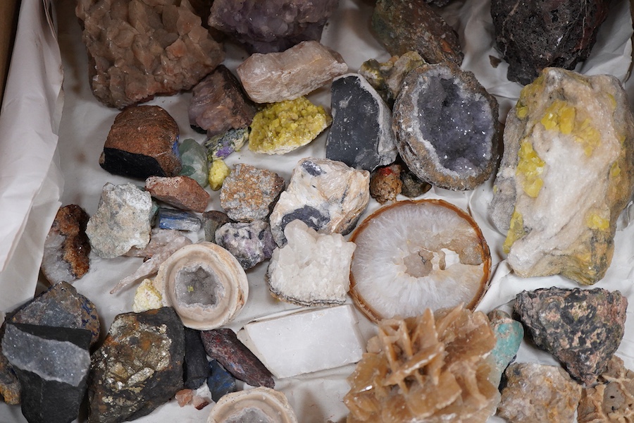 A collection of mineral and crystal samples, including large quartz segments and a good variety of other crystal formations